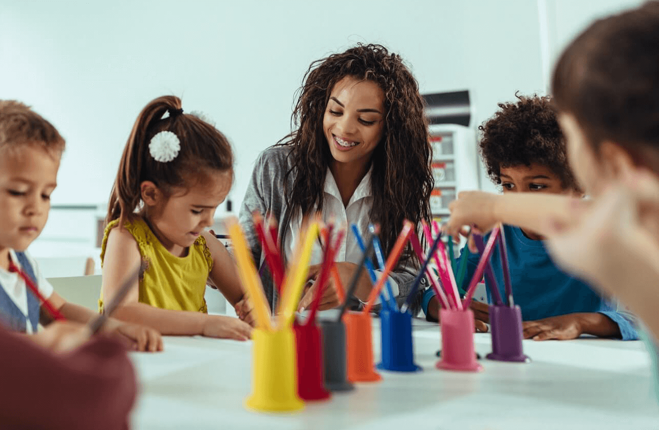 Woman smiling while teaching children with developmental needs